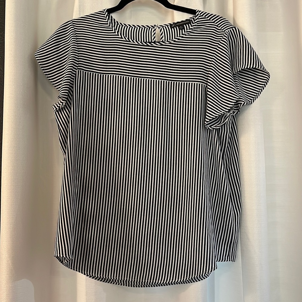 Adrianna Papell navy with white stripes shirt with short flowy sleeves.